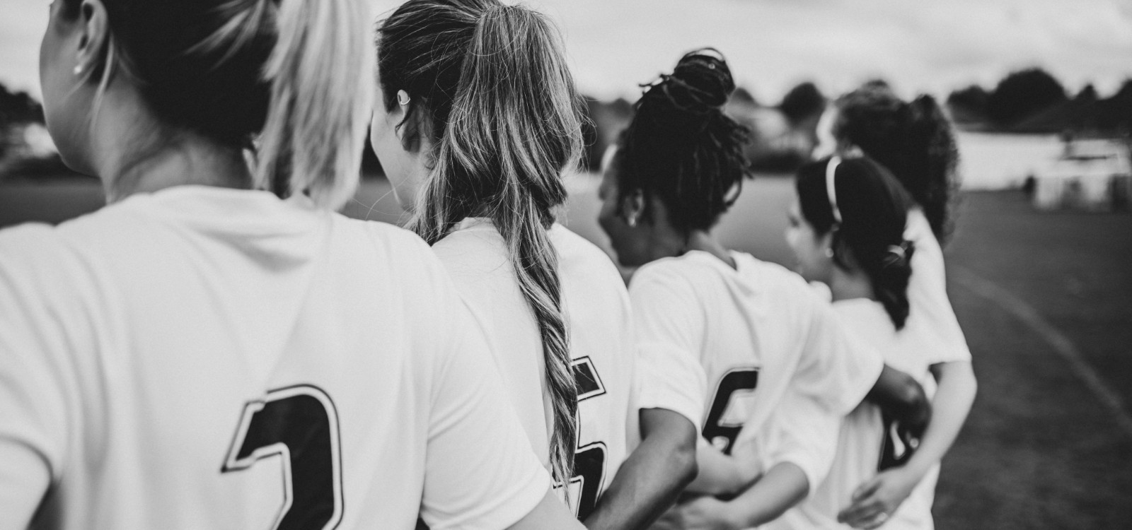 Back view of women footballers in a line