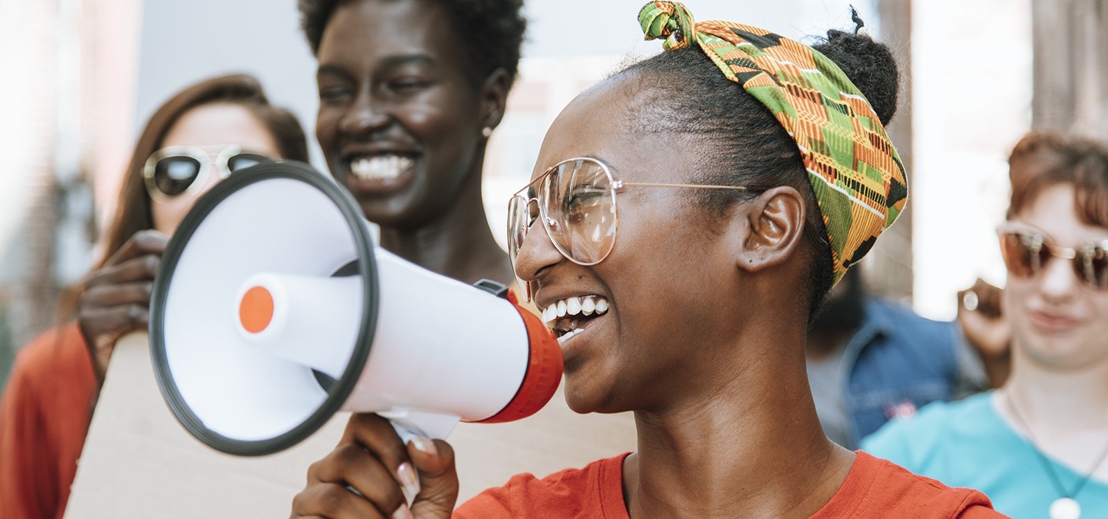 Young Black woman with a megaphone. Smiling