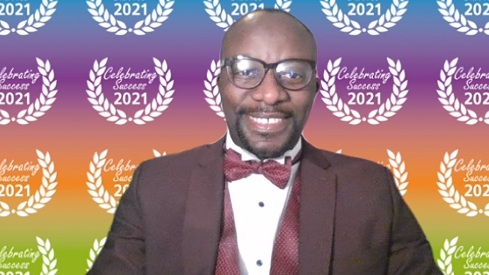 A black man in dinner jacket at awards ceremony